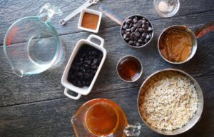 Ingredients for No Bake Granola Bars on a gray surface.