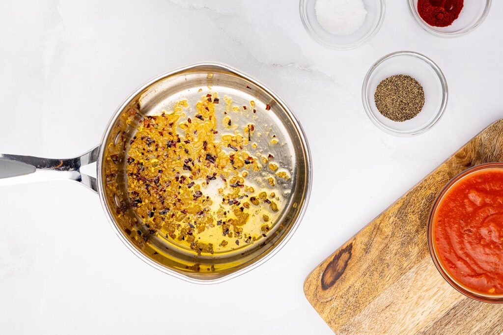 Heated spices and oil in a pot.