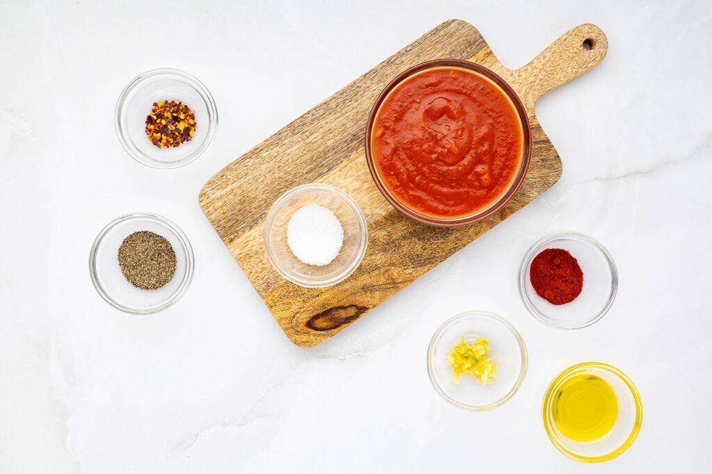 Marinara dipping sauce ingredients in individual bowls.