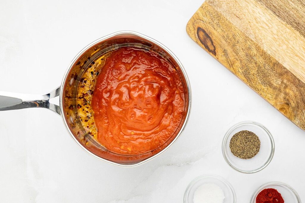 Marinara added to the pot of oil and spices.