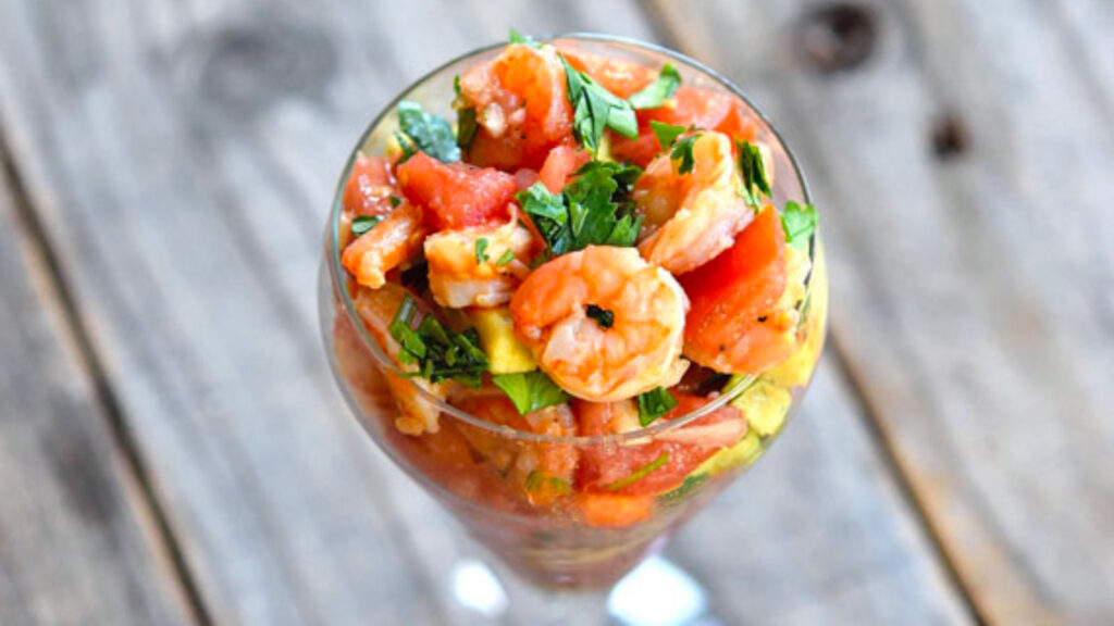 A glass filled with shrimp campachana.