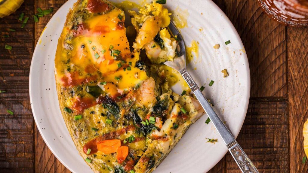 An overhead view of a shrimp and spinach omelette.