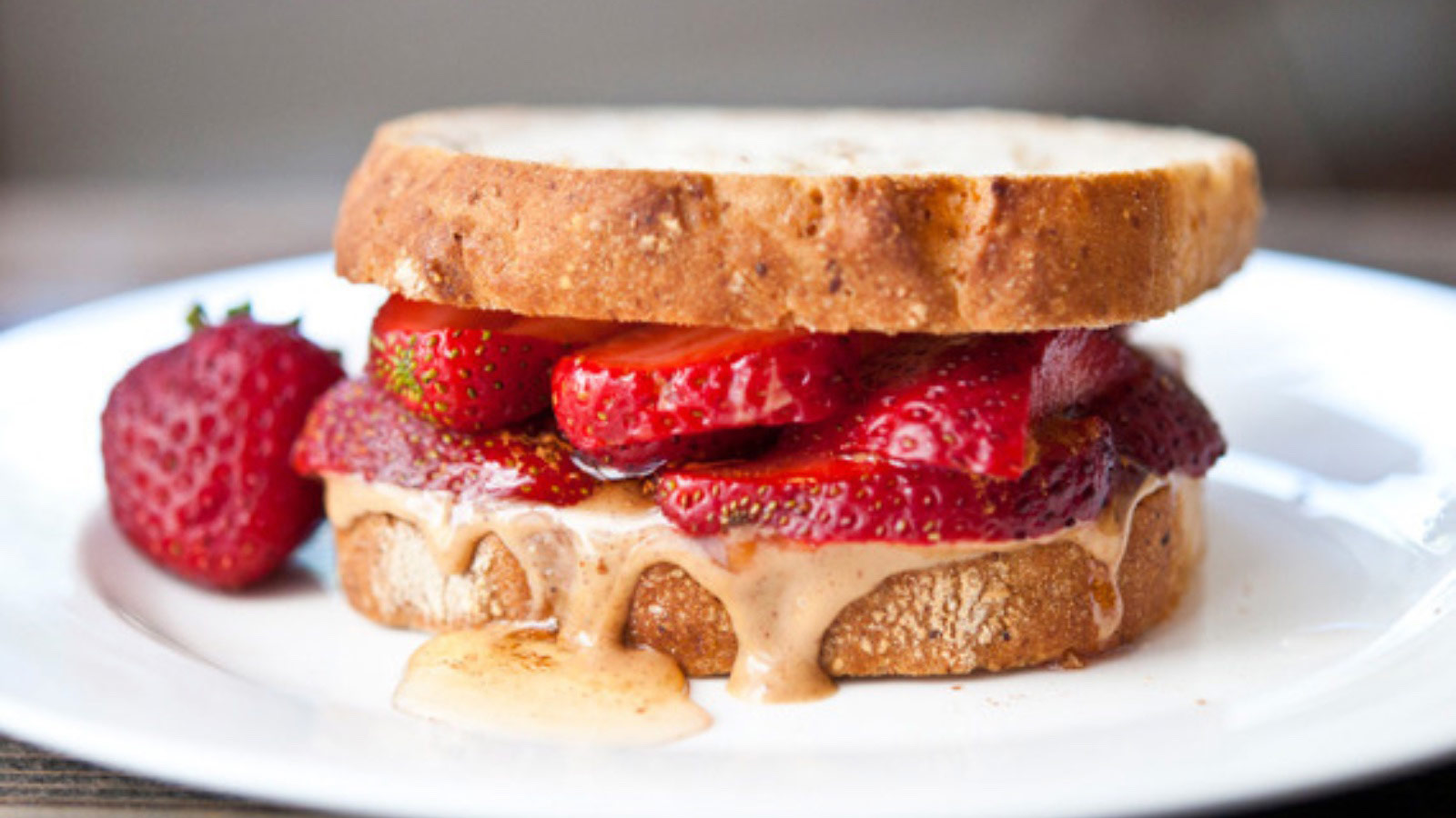 A strawberry sandwich on a white plate.