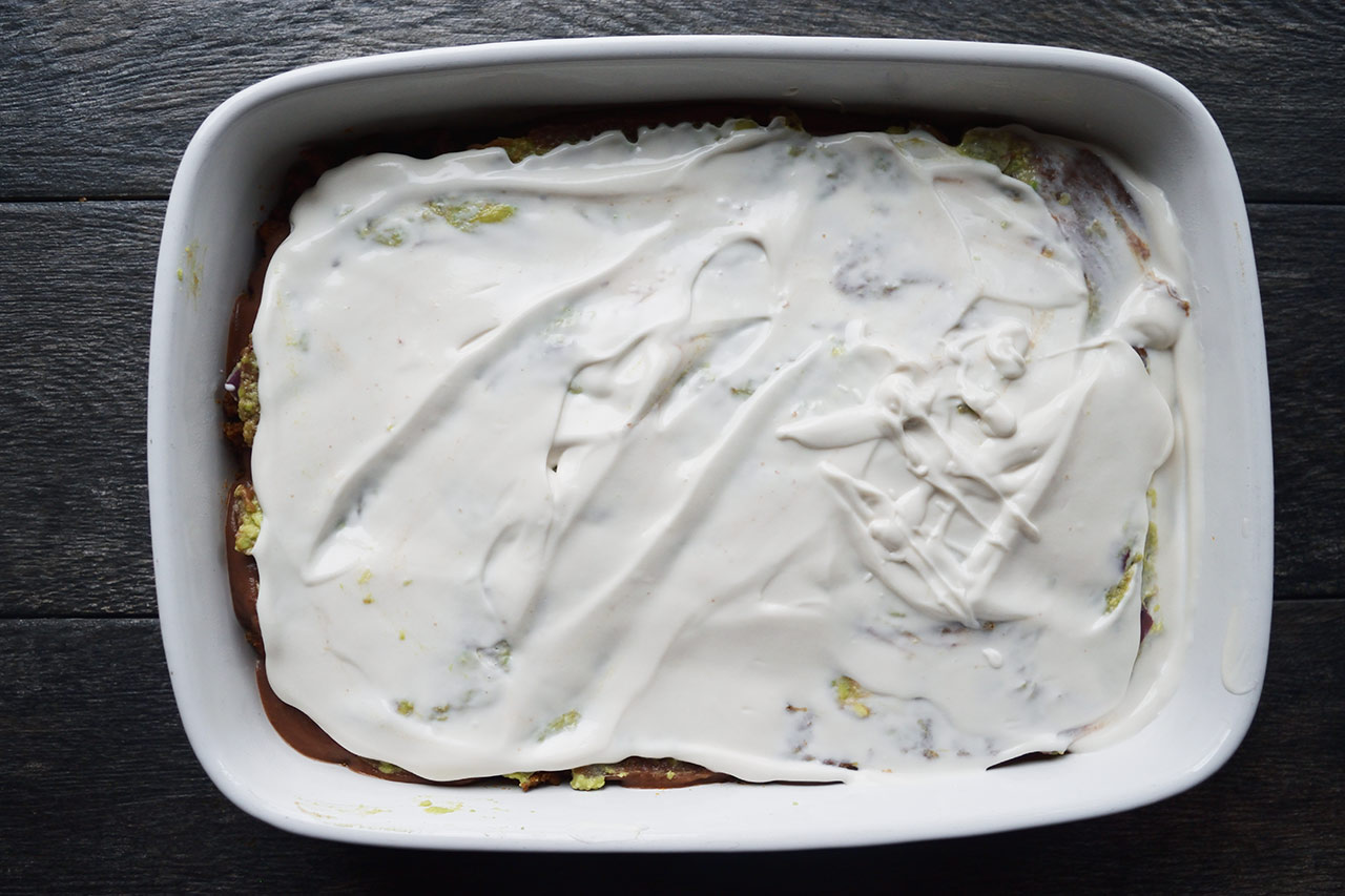 A layer of yogurt spread over a Taco Salad Casserole.