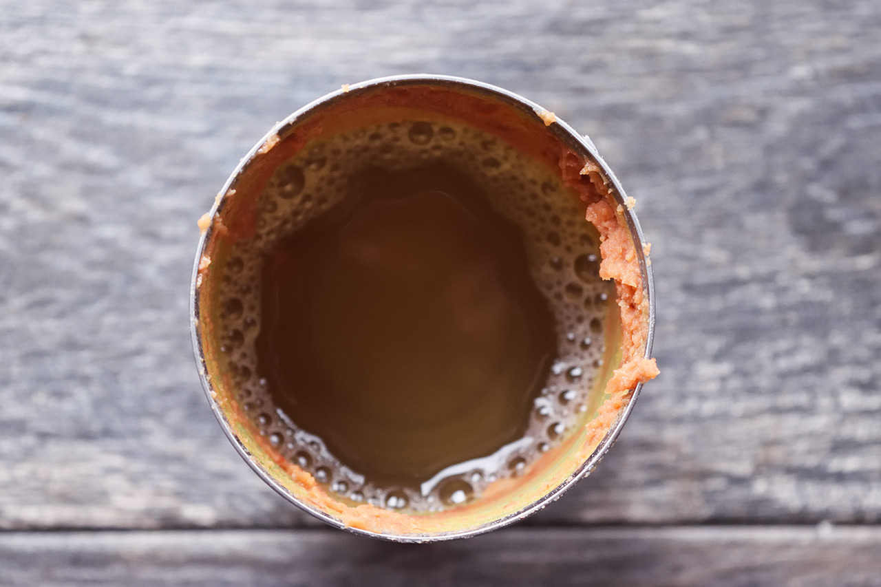 An empty refried bean can filled three quarters of the way with water.