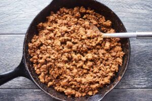 Cooked taco meat in a cast iron skillet.