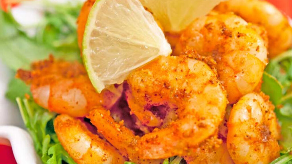 A closeup of taco shrimp with a lime slice.