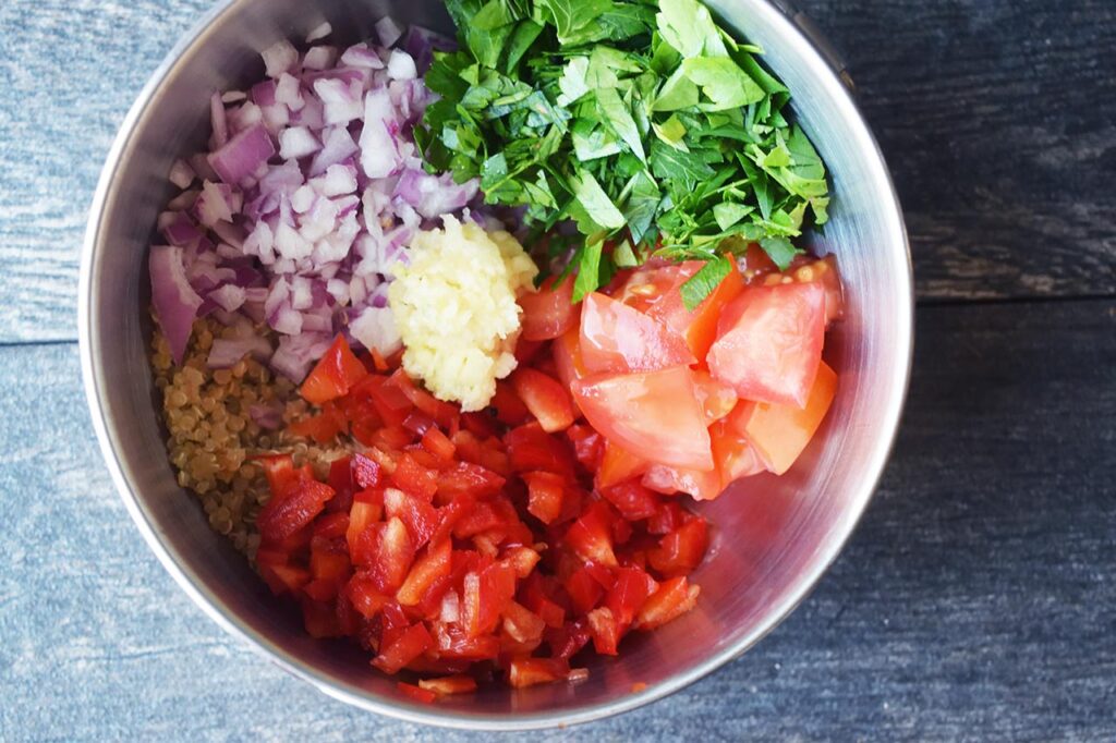 Zucchini Boats recipe ingredients added to a metal mixing bowl.