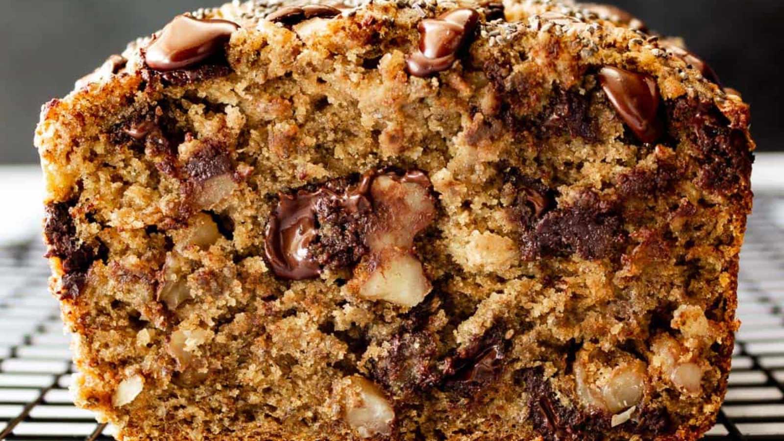 A closeup of the cut side of a chocolate chip chia banana bread loaf.