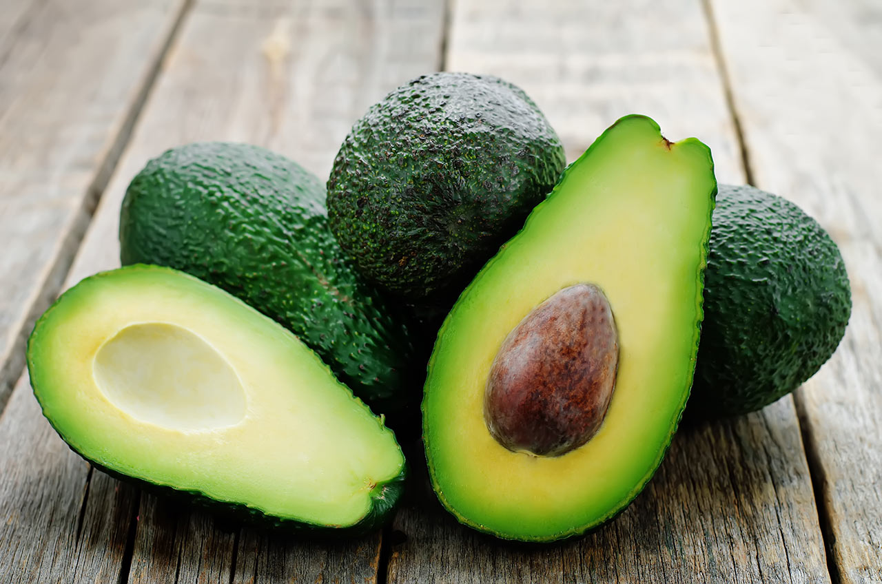 Avocados on a dark wood background. Selective focus.