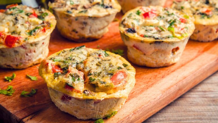 Southwestern breakfast muffins lined up on a cutting board.