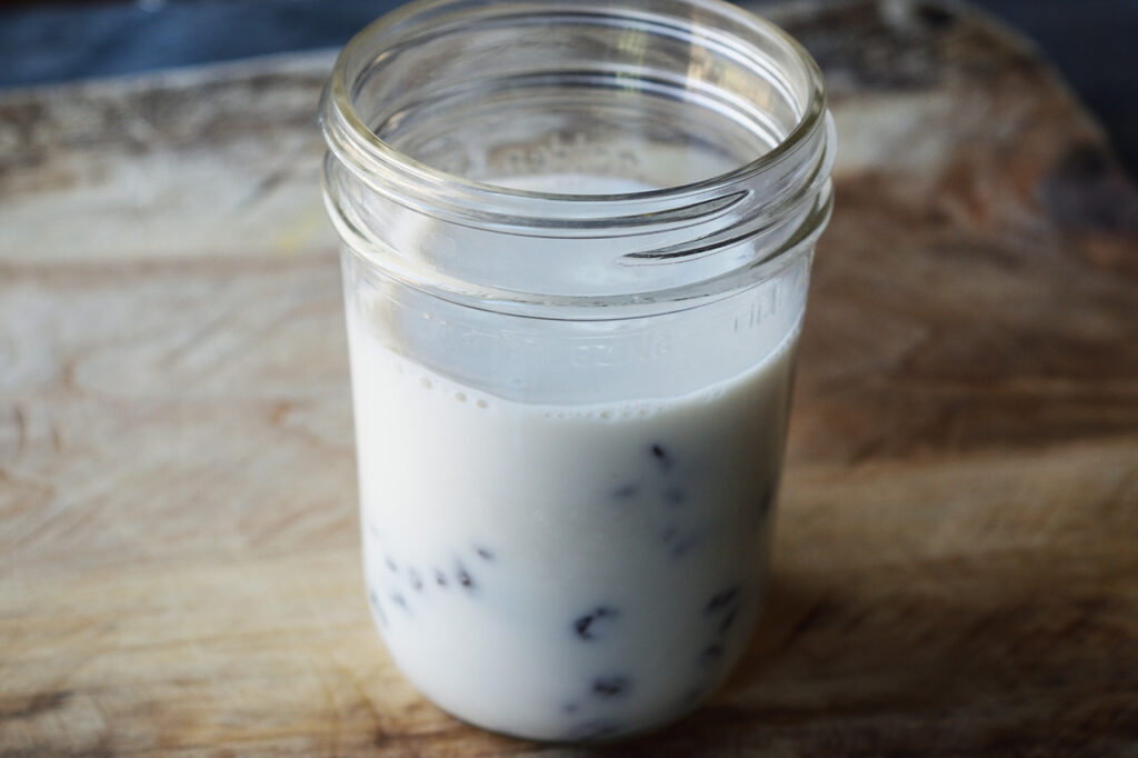 Condensed milk recipe ingredients combined in a canning jar.