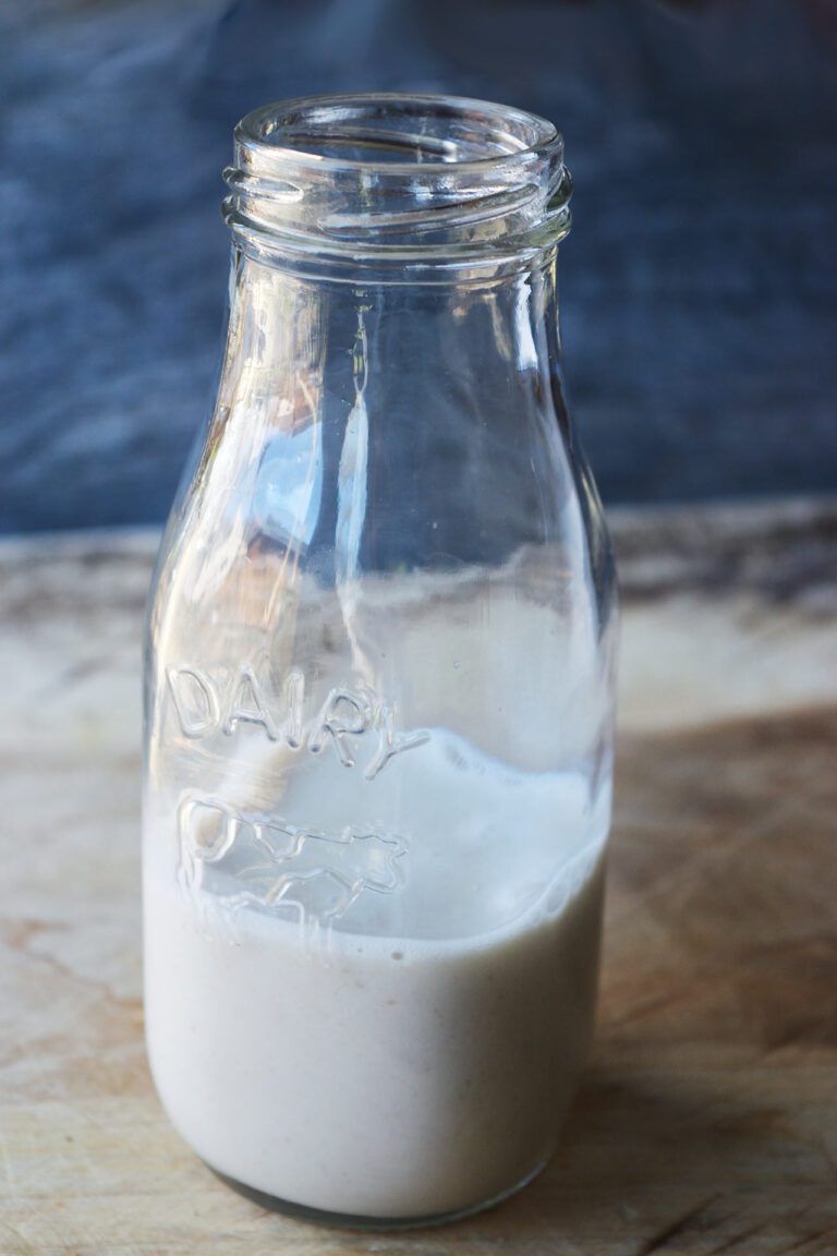 A glass jar partially filled with Condensed Milk.
