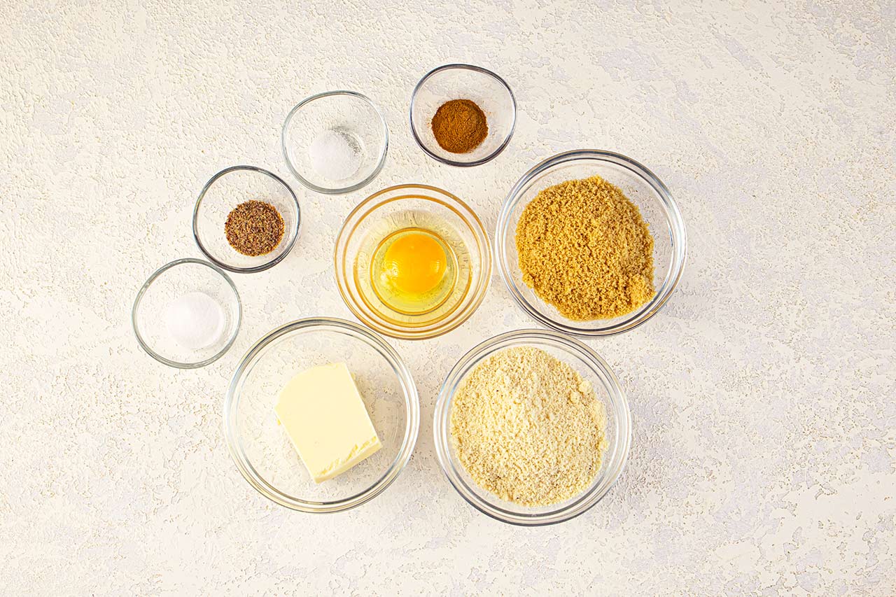 Graham Cracker Recipe ingredients in separate bowls, sitting on a countertop.