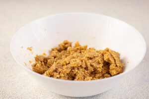 The mixed Graham Cracker dough in a white mixing bowl.