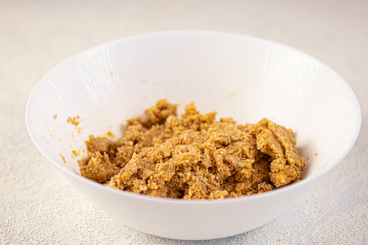 The mixed Graham Cracker dough in a white mixing bowl.