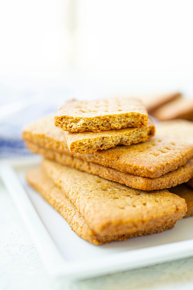 A stack of graham crackers on a white platter.