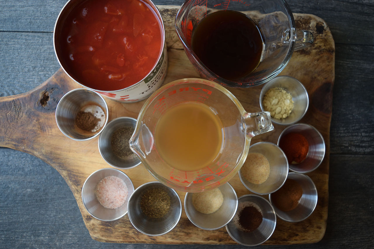 Ingredients gathered in individual containers on a cutting board for this Kktchup recipe.