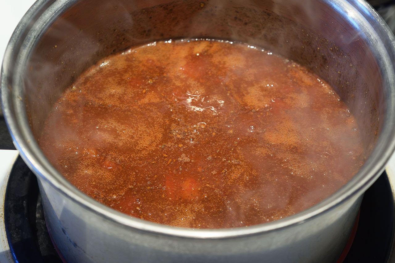 Ketchup simmering in a pot.