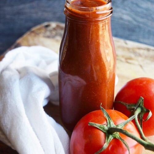 A front view of a jar of homemade ketchup.