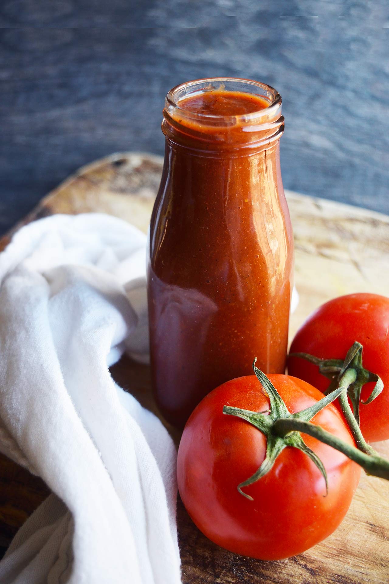 A front view of a jar of homemade ketchup.