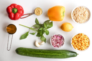 Rainbow Orzo Salad recipe ingredients on a white background.