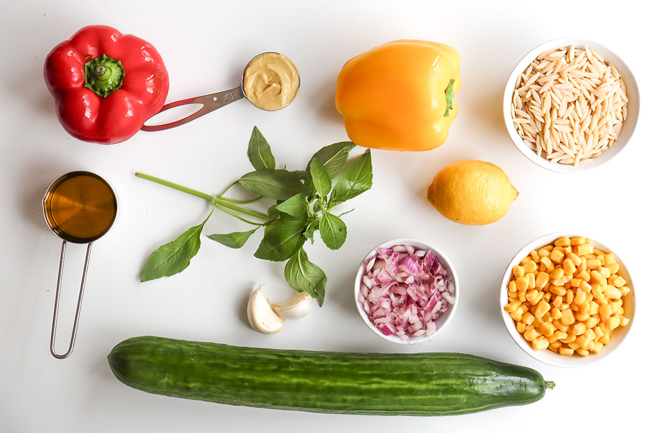 Rainbow Orzo Salad recipe ingredients on a white background.