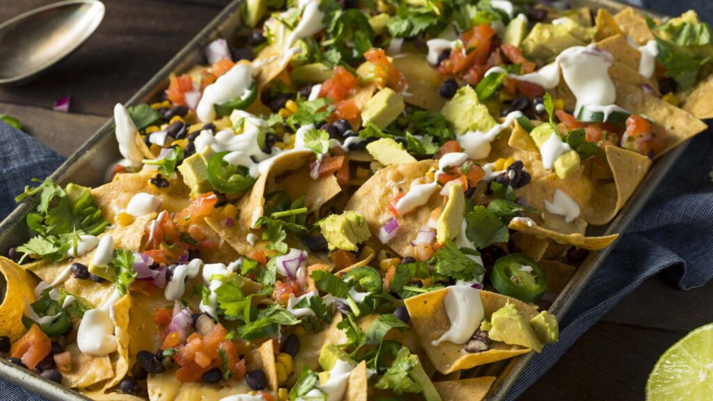 Homemade Loaded Sheet Pan Nachos on a tabletop.