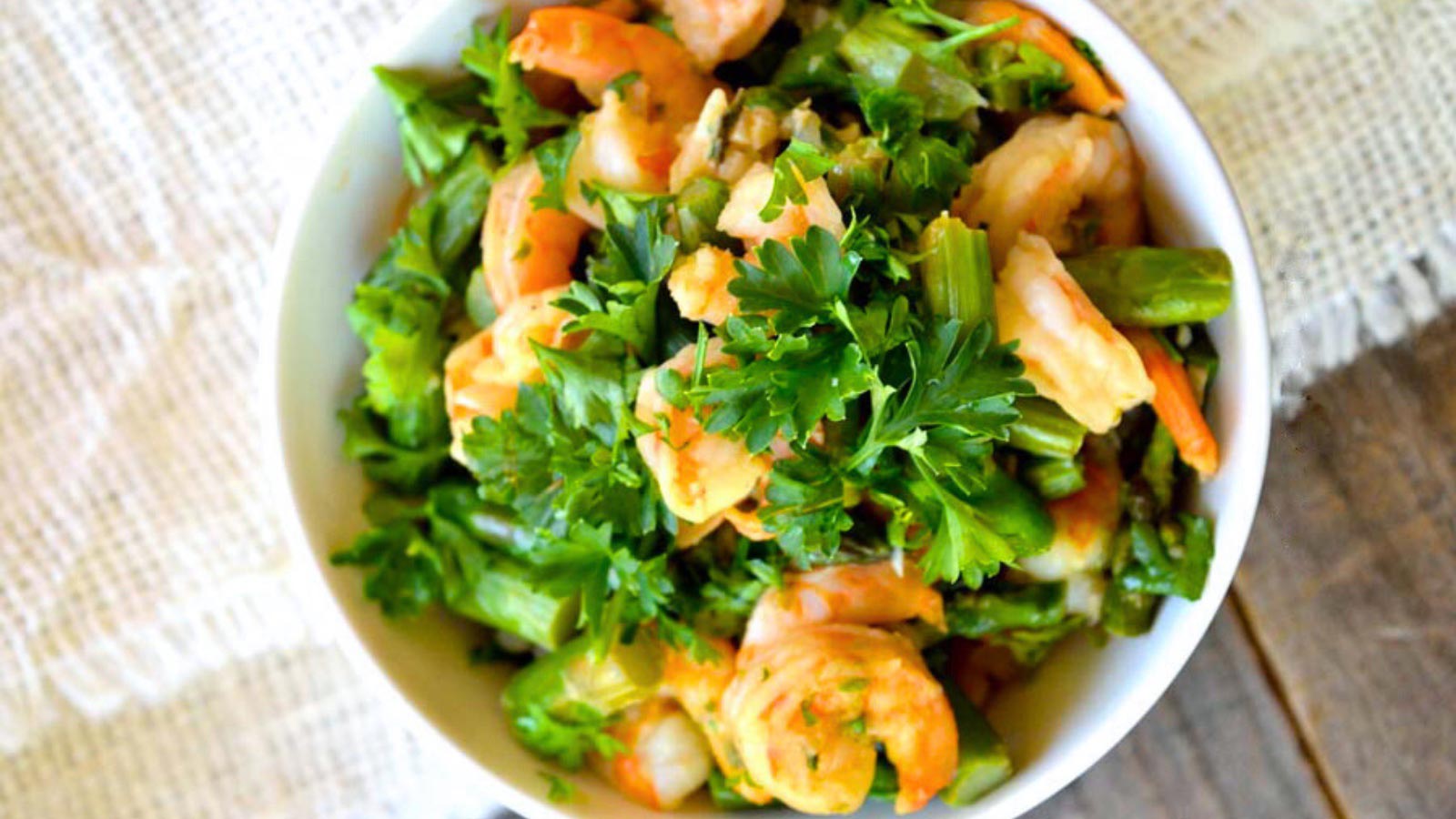 An overhead view of a white bowl filled with this Shrimp And Asparagus Skillet recipe.