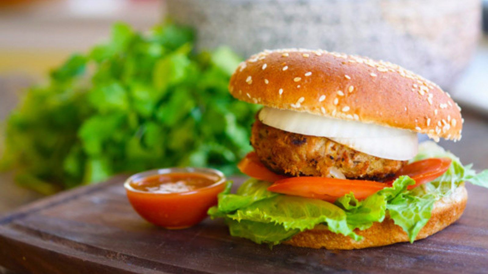 A taco burger sitting on a cutting board.