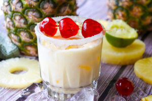 A side view of a glass filled wtih Virgin Pina Colada.