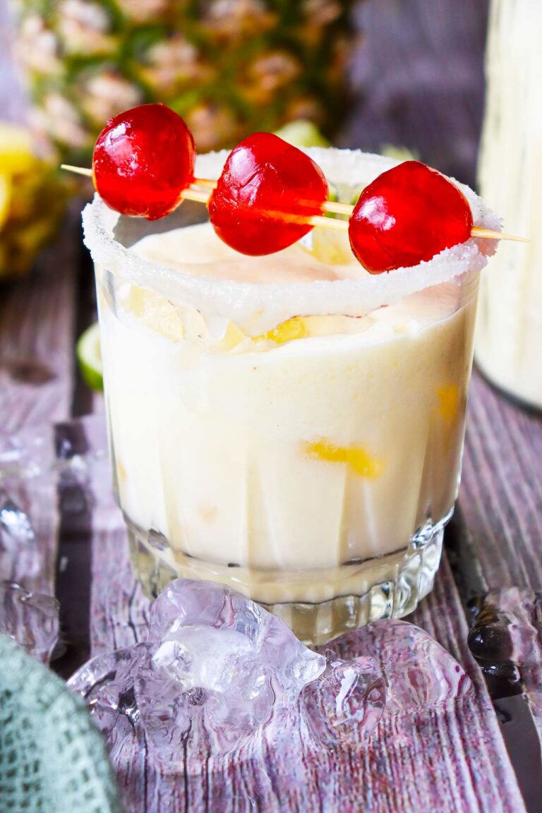 A side view of a glass full of Virgin Pina Colada.