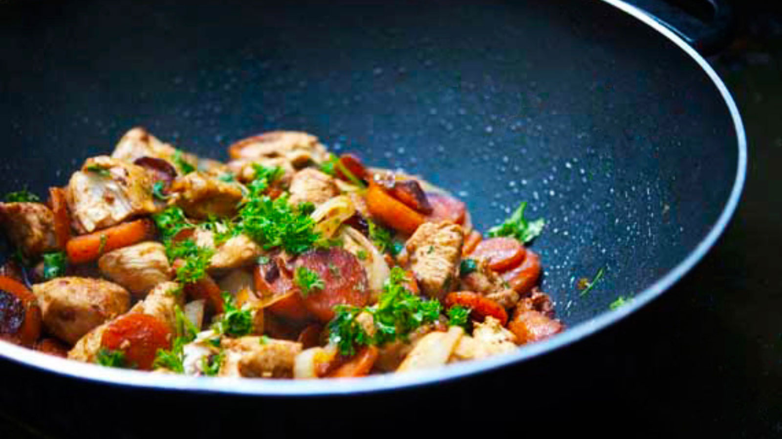Wok-Style Garlic Chicken & Carrots in a black wok.