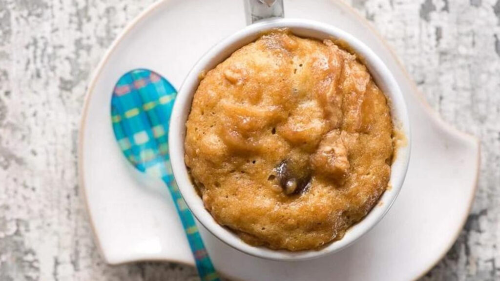An overhead view of a mug filled with peanut butter lovers chocolate chip mug cake.