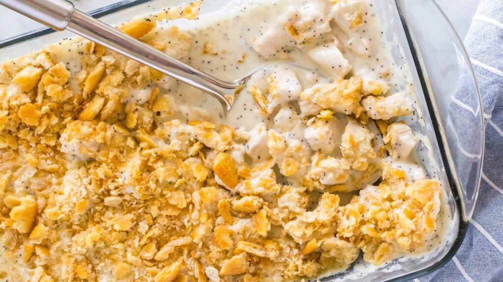 A glass casserole dish filled with poppy seed chicken. Overhead focus.