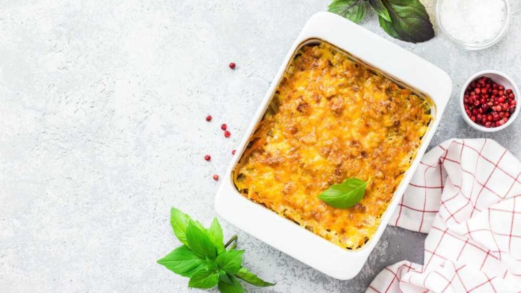 A squash casserole in a white baking dish. Overhead focus.