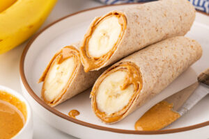 The finished banana wraps, cut and sitting on a white plate.