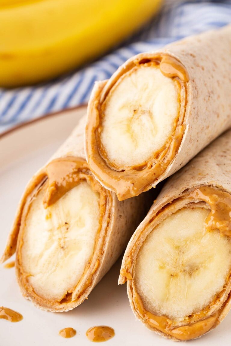 A closeup of three cut banana wrap halves on a plate.