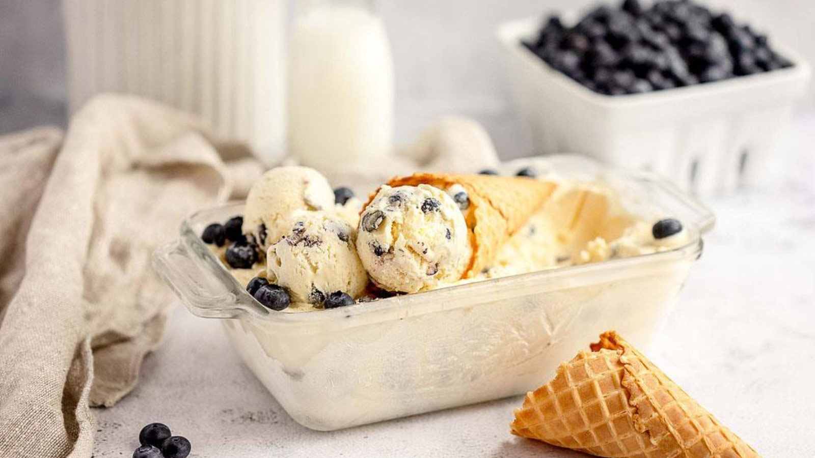 A dish filled with blueberry cheesecake ice cream.