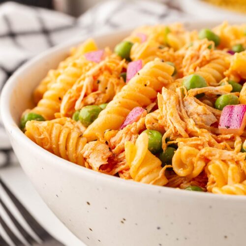 A white bowl full of Buffalo Chicken Pasta Salad shown from the side.