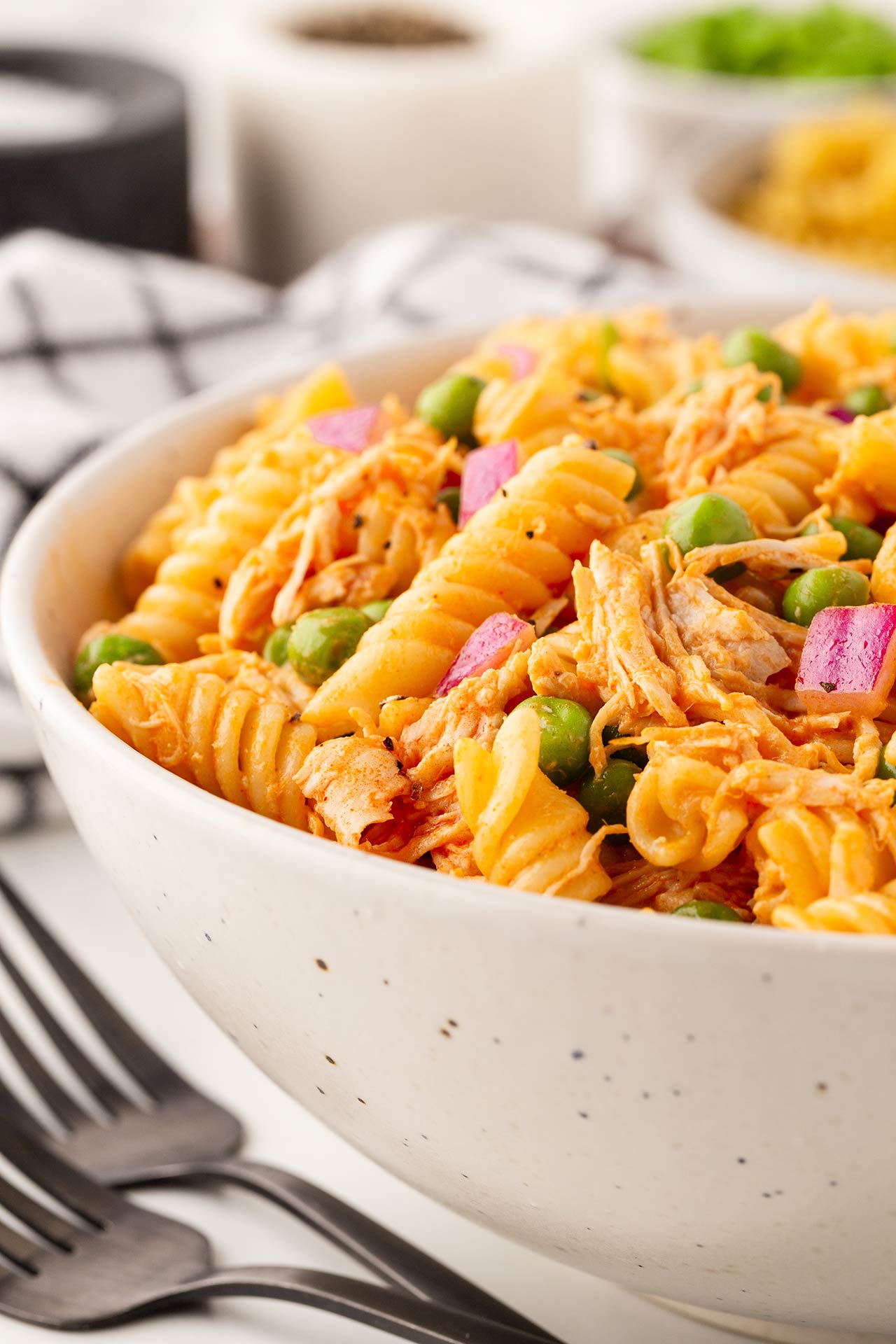 A white bowl full of Buffalo Chicken Pasta Salad shown from the side.