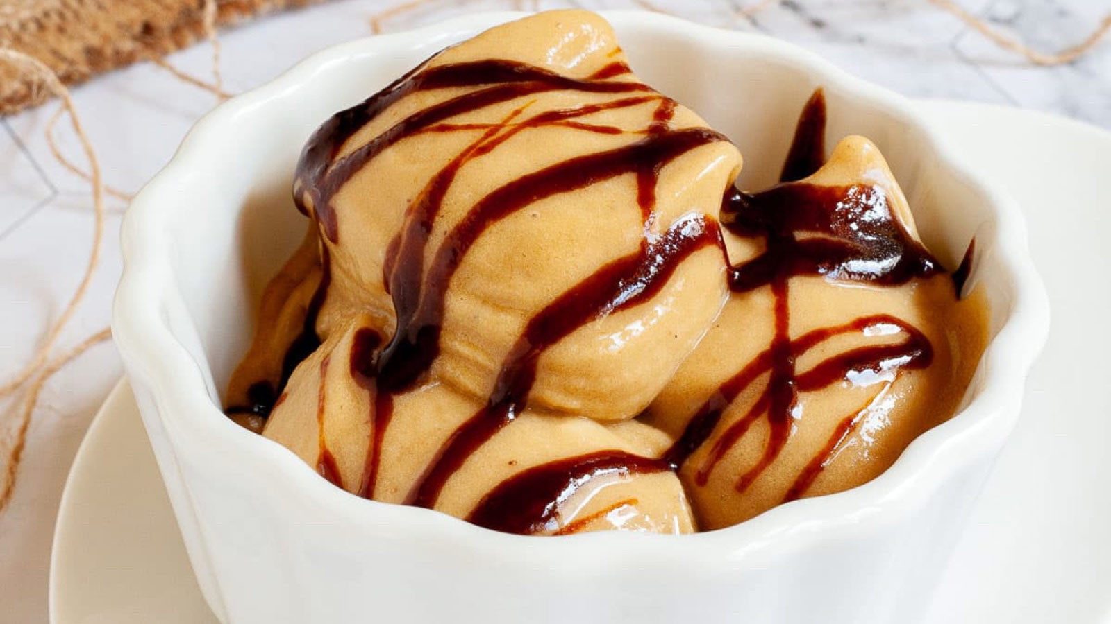 A white bowl filled with caramel nice cream.