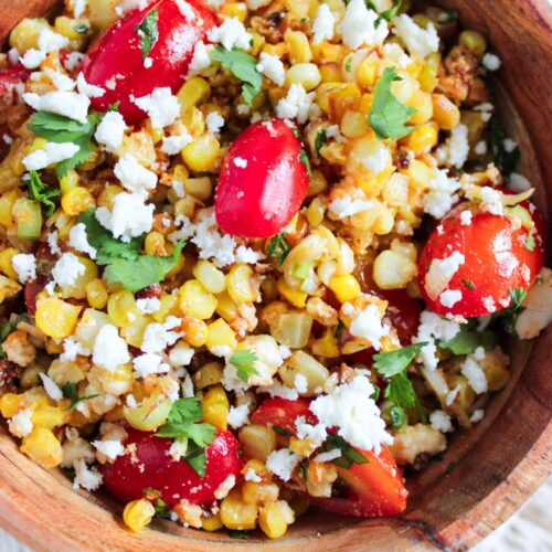A wood bowl full of Roasted Corn Salad.