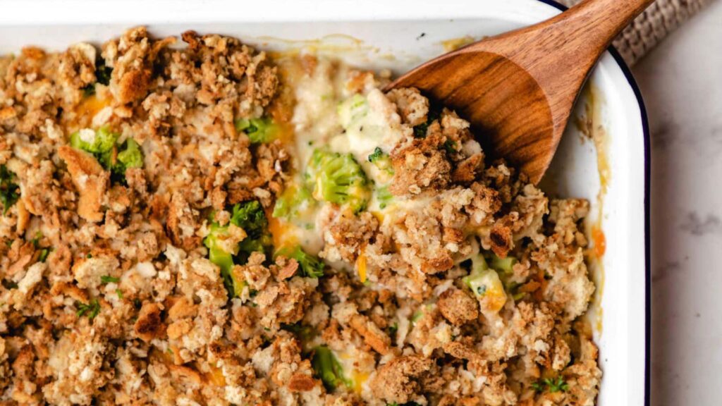 A closeup of a white casserole dish filled with chicken broccoli stuffing casserole.