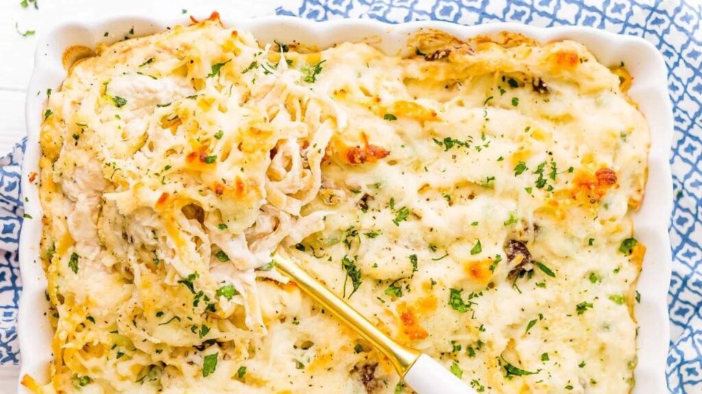 A white casserole dish filled with chicken tetrazzini. Overhead focus.