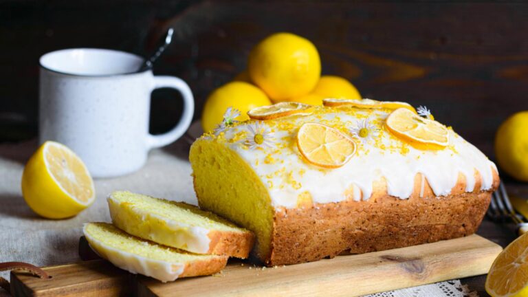 Lemon loaf cake, classic recipe, decorated with icing and lemon slices.