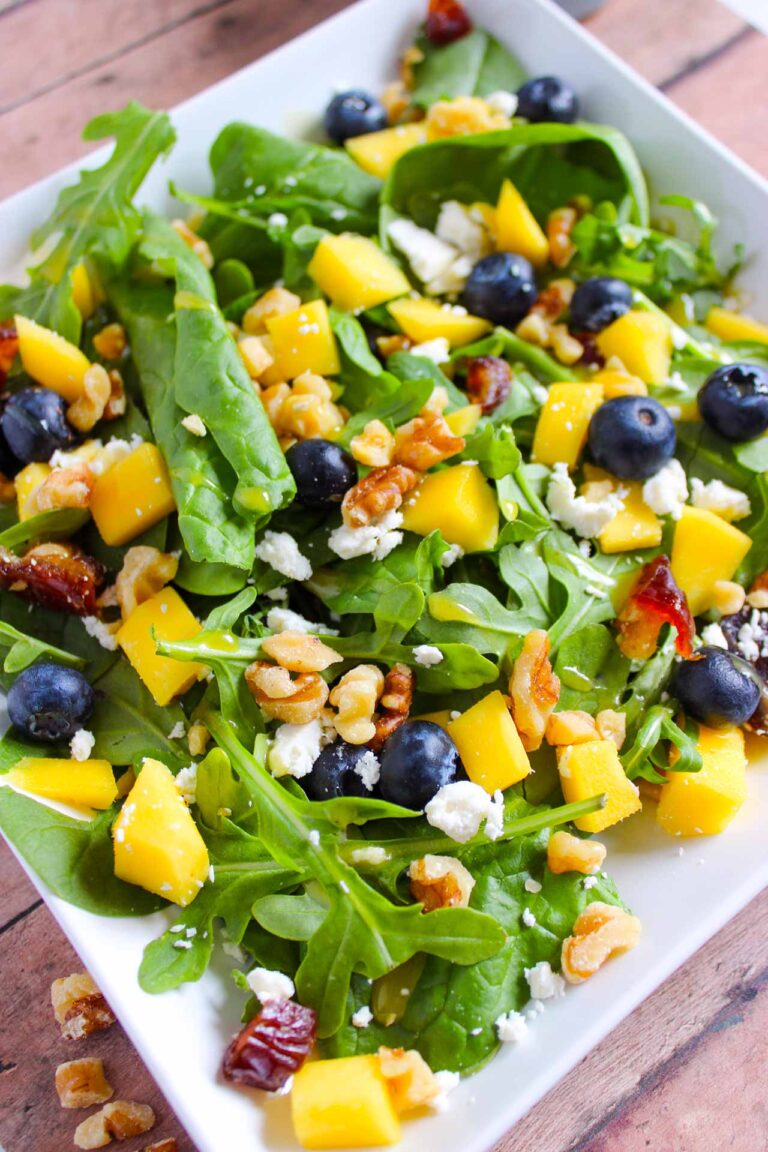 A white platter filled with Mango Blueberry Salad.