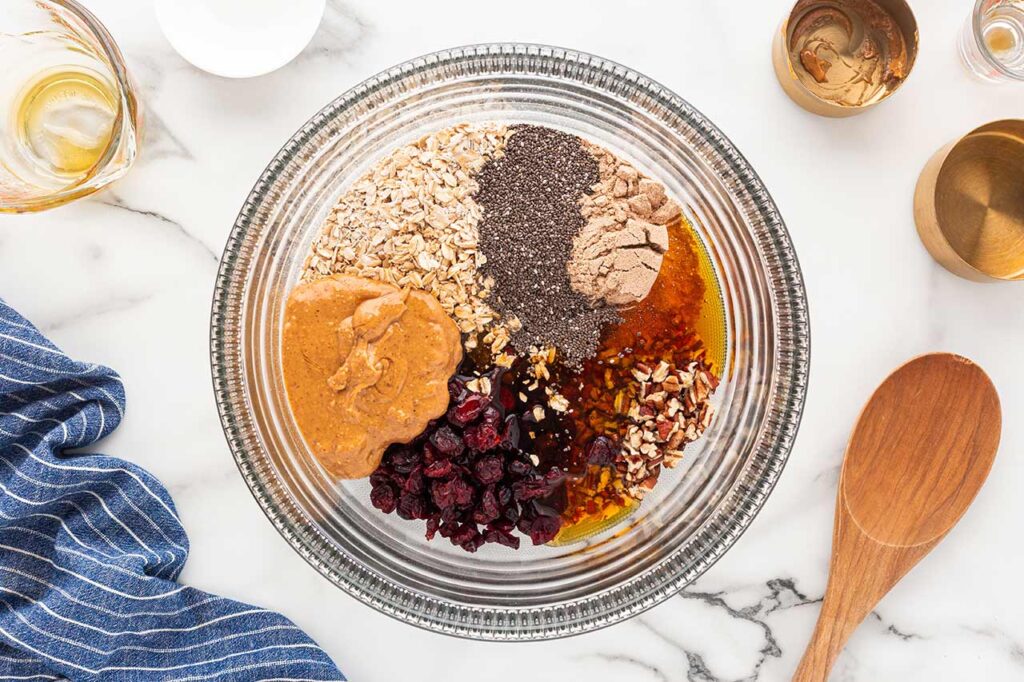 All no-bake cookie ingredients in a glass mixing bowl.