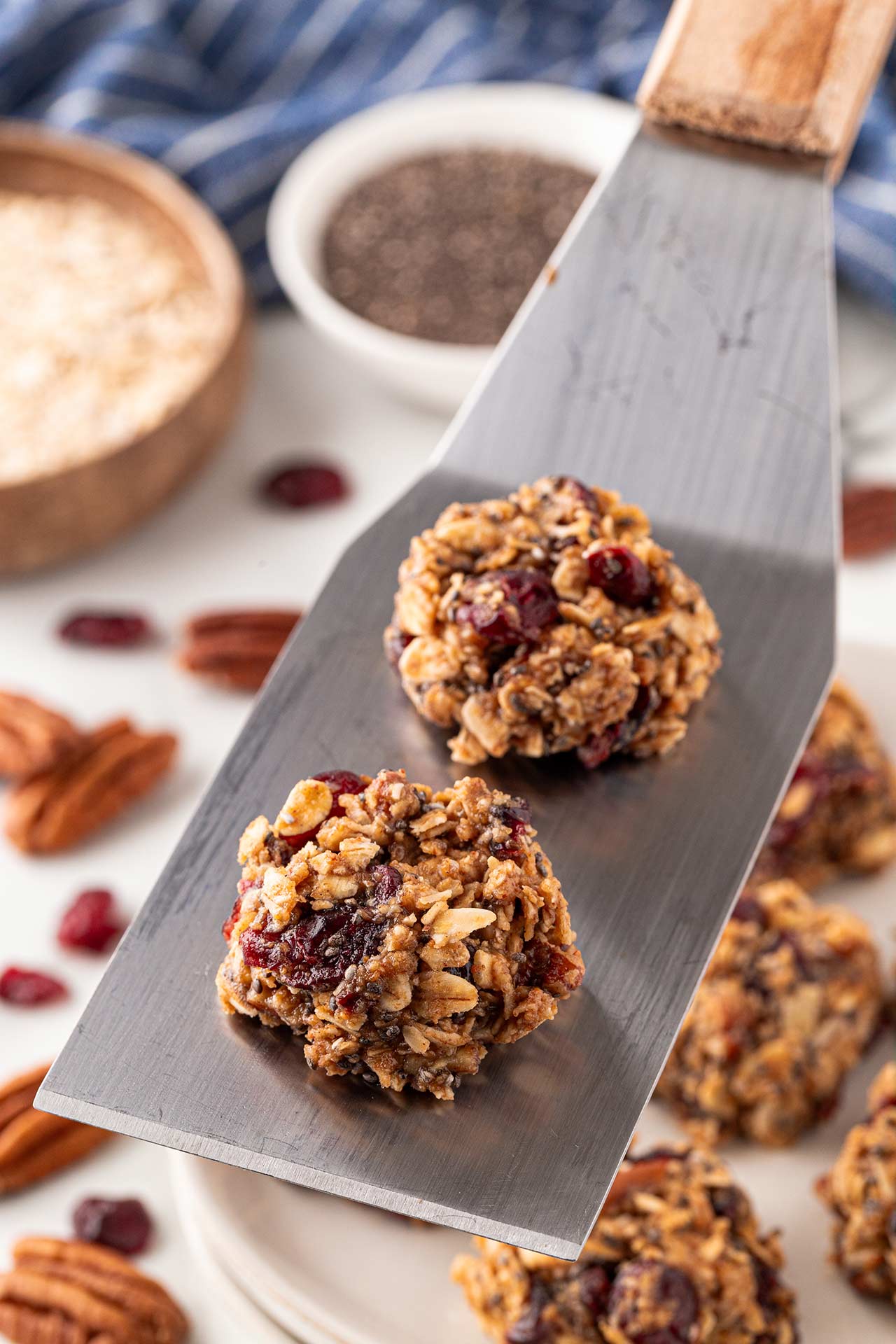 A metal spatula holds two no-bake cookies.