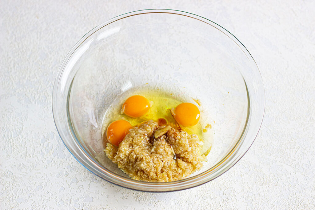 Wet ingredients for oatmeal cake in a mixing bowl.